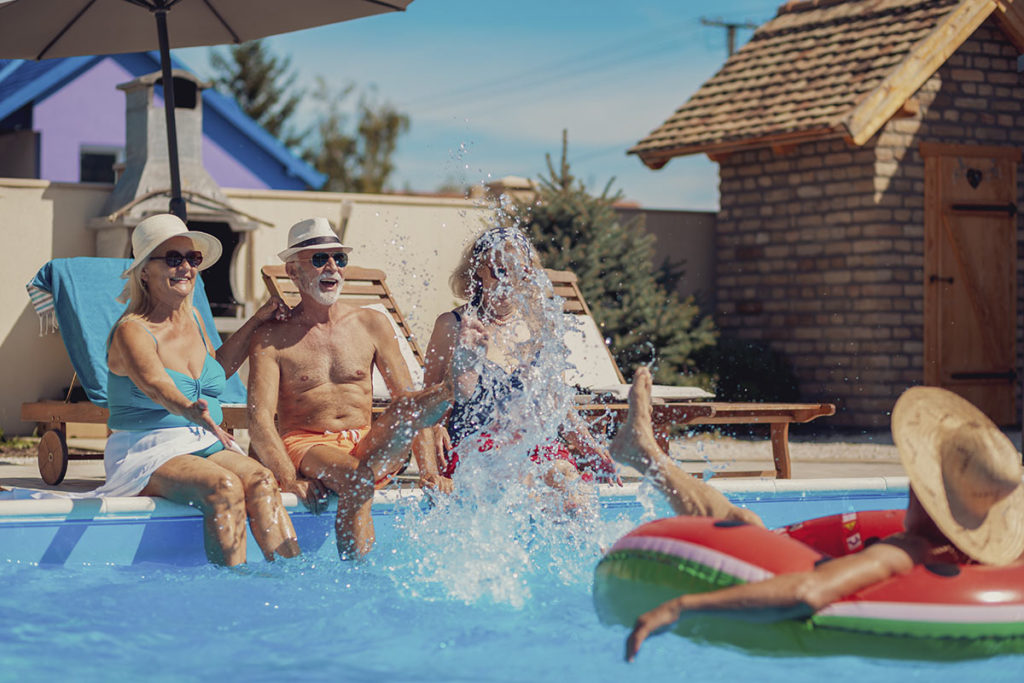 elderly friends having fun at pool